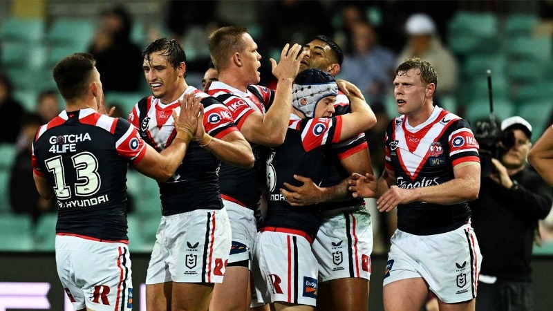 BROWN MARCHED AS ROOSTERS DOWN MANLY