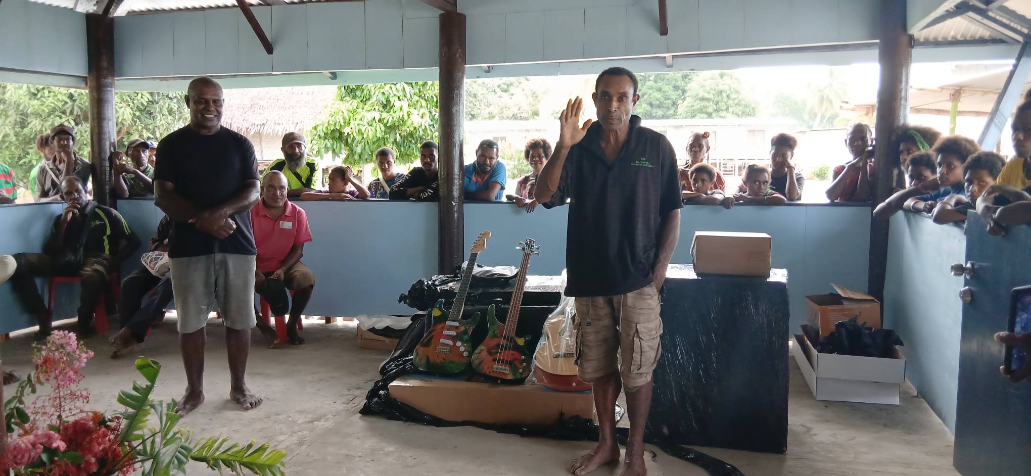 JASON PETER PRESENTS MUSICAL INSTRUMENTS TO BAYA PARISH IN REMOTE HUON GULF COMMUNITY